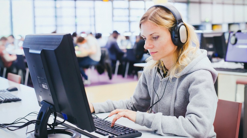 Adult student studying English with focused concentration